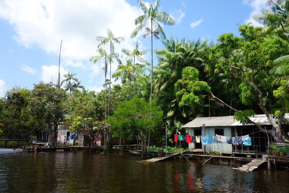 Einfache Wohnhäuser an einem Fluss in den Tropen